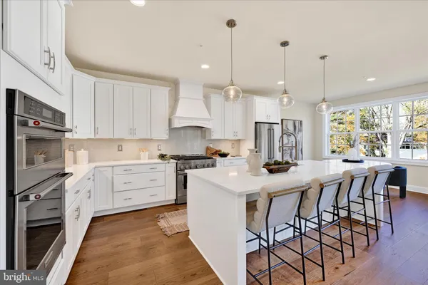 a kitchen with stove a sink and a refrigerator