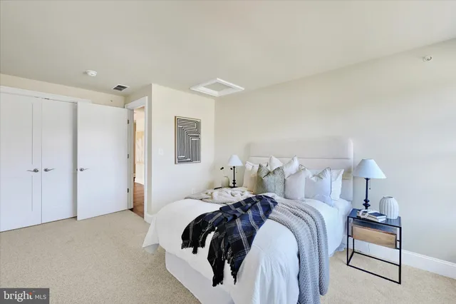 a spacious bathroom with a double vanity sink mirror and toilet