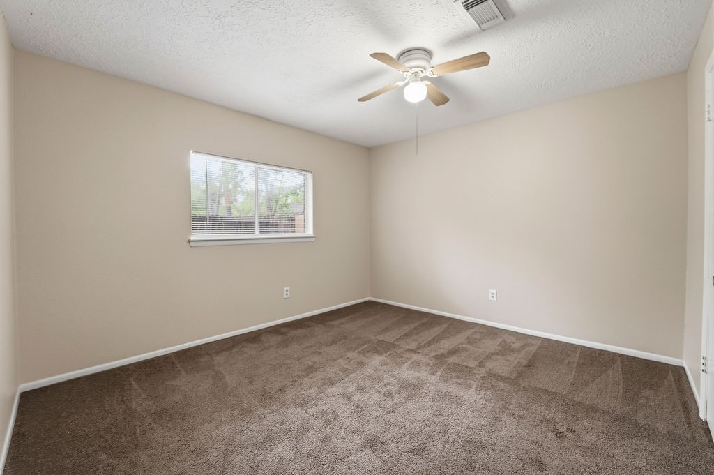 4542 Algernon Drive Spring, TX 77373 - Photo 11 of 19 an empty room with windows and fan