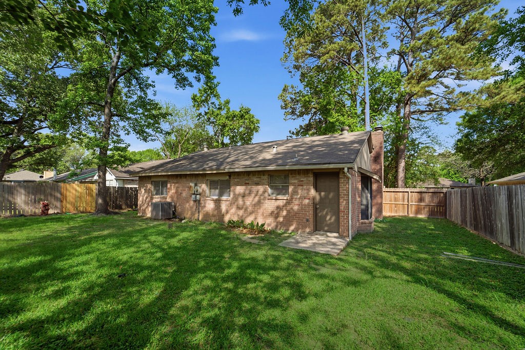 4542 Algernon Drive Spring, TX 77373 - Photo 17 of 19 a view of a wooden fence under a large tree
