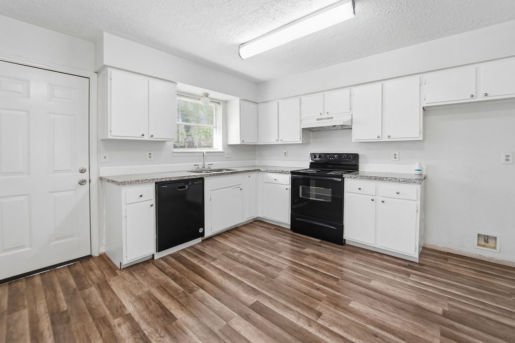 4542 Algernon Drive Spring, TX 77373 - Photo 6 of 19 a kitchen with granite countertop white cabinets and white appliances