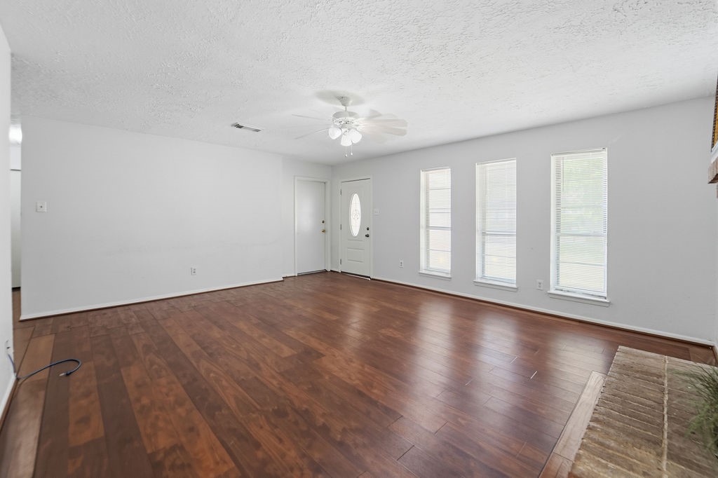 4542 Algernon Drive Spring, TX 77373 - Photo 7 of 19 an empty room with wooden floor and windows