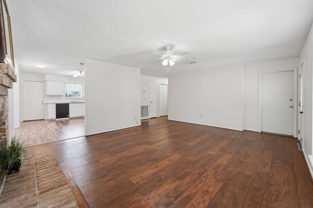 4542 Algernon Drive Spring, TX 77373 - Photo 9 of 19 a view of empty room with wooden floor and kitchen view