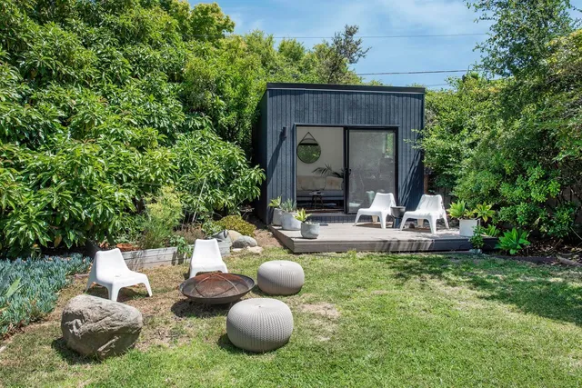 a view of a chairs and table in backyard