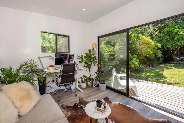 a living room with furniture and a floor to ceiling window