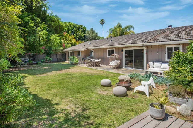 a front view of house with yard and outdoor seating
