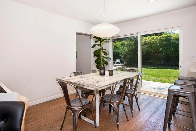 a view of a dining room with furniture wooden floor and chandelier