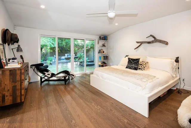 a bedroom with a bed and a wooden floor