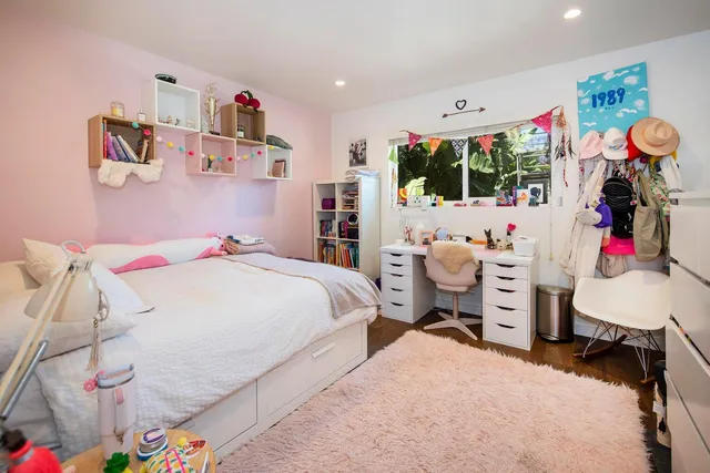 a bedroom with a bed and a window