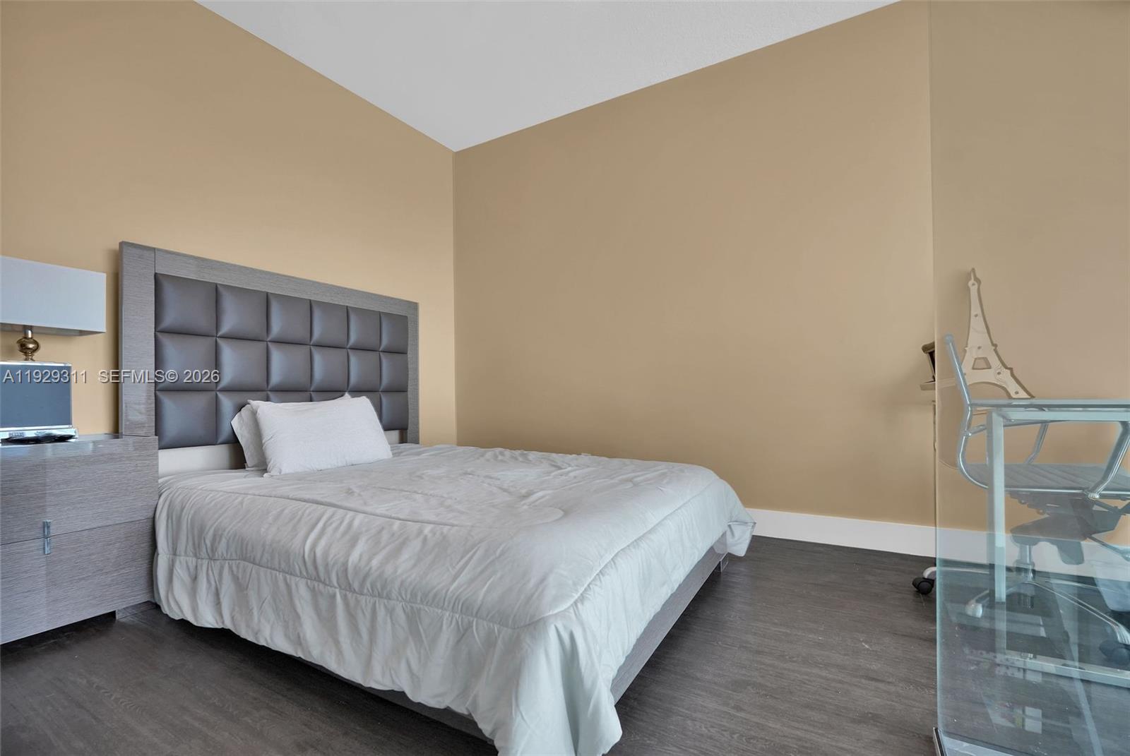 60 Southwest 13th Street, Unit 4607 Miami, FL 33130 - Photo 16 of 39 a bedroom with a bed and wooden floor