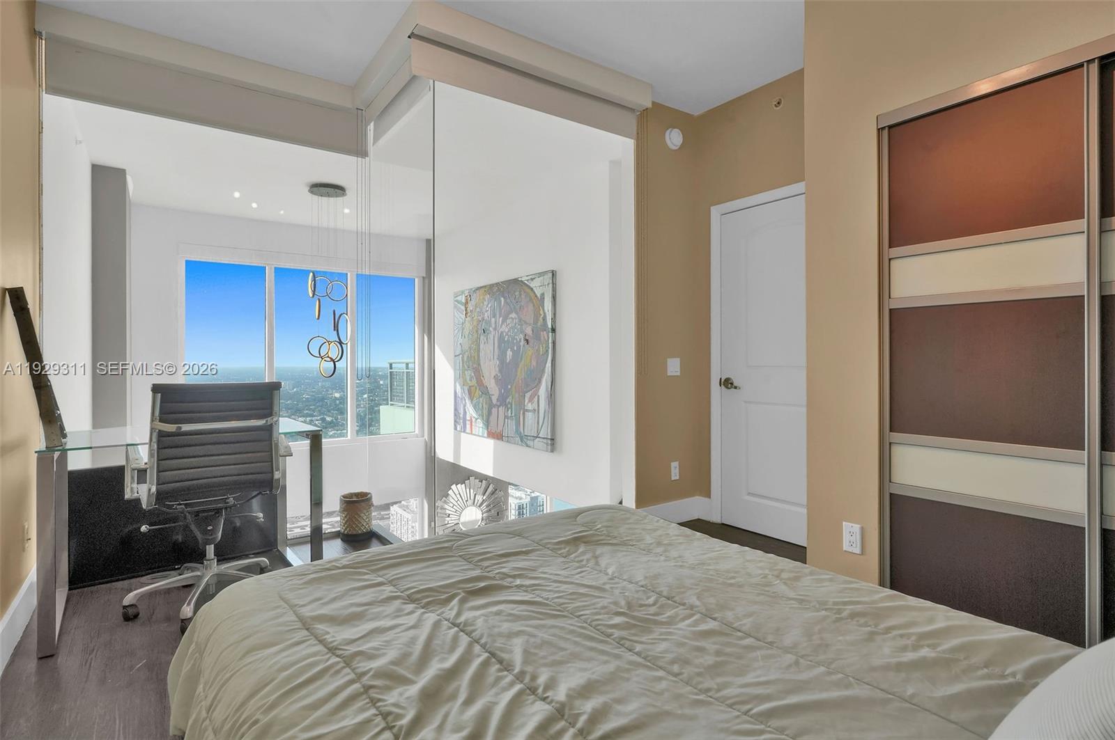 60 Southwest 13th Street, Unit 4607 Miami, FL 33130 - Photo 17 of 39 a bedroom with a bed and a dresser with mirror