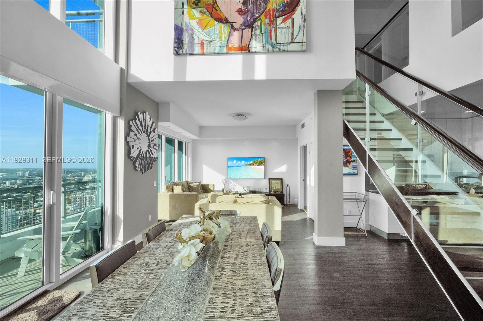 60 Southwest 13th Street, Unit 4607 Miami, FL 33130 - Photo 2 of 39 a living room with furniture and wooden floor