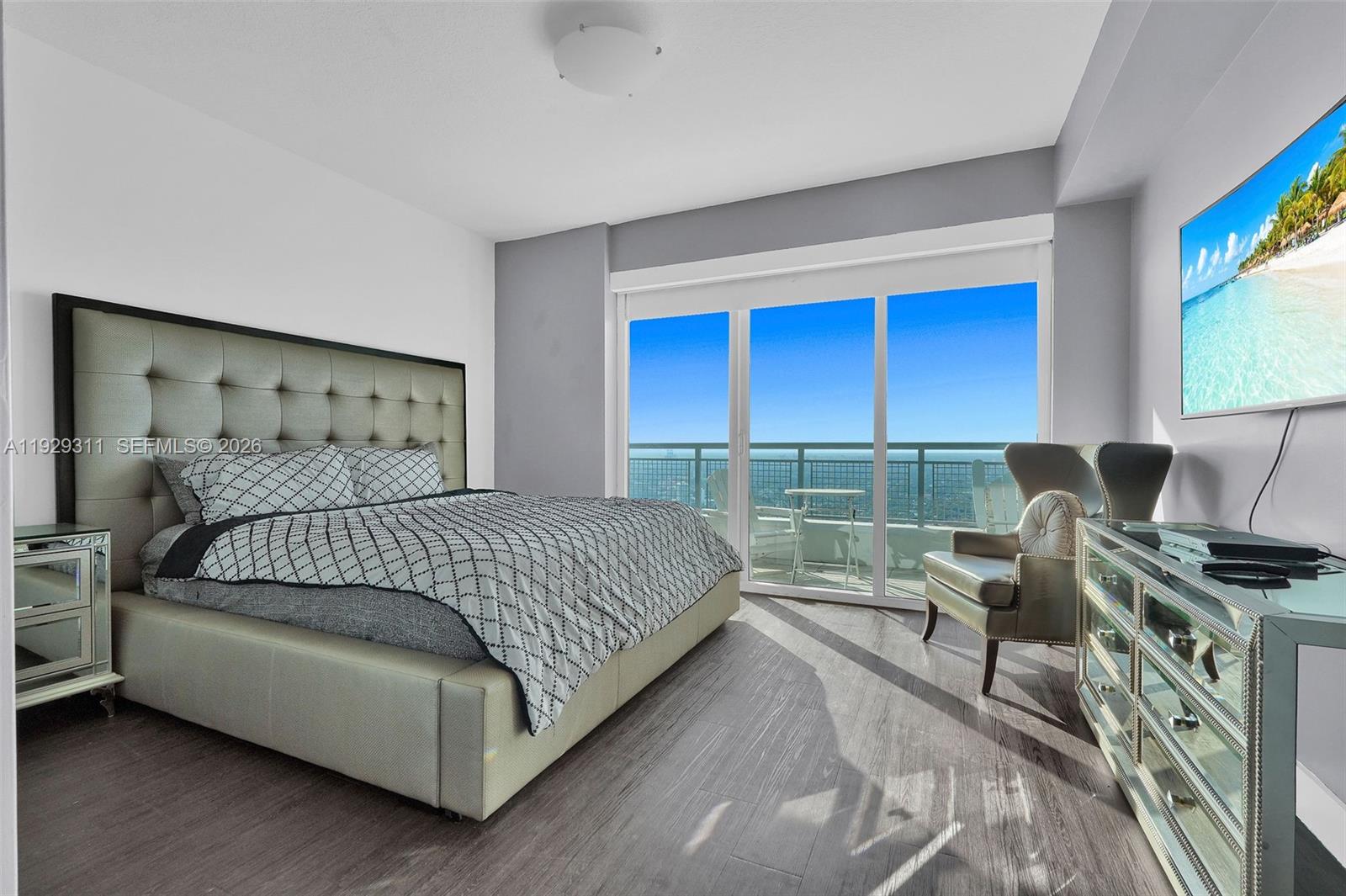 60 Southwest 13th Street, Unit 4607 Miami, FL 33130 - Photo 21 of 39 a bedroom with a bed and a flat tv screen on dresser
