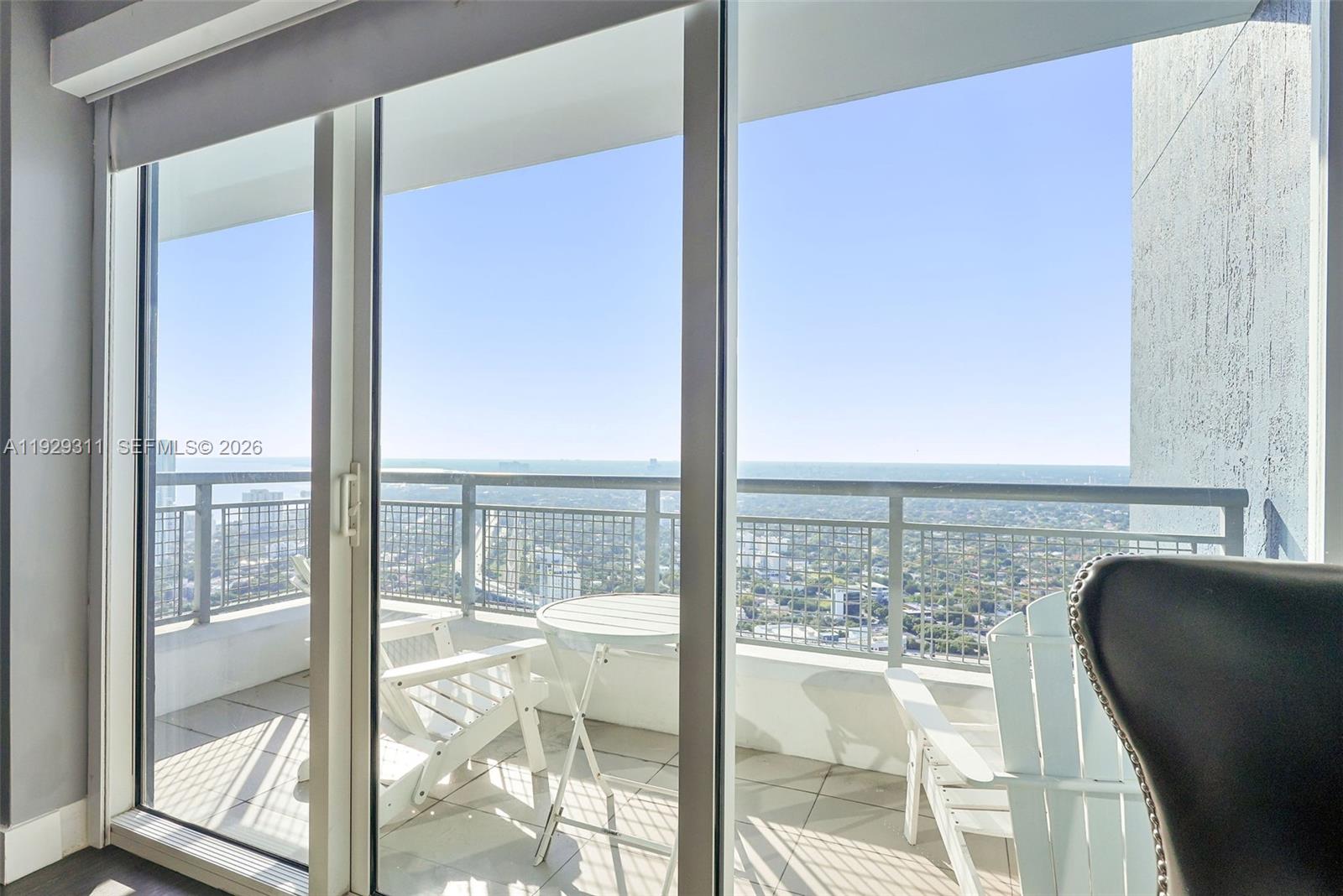 60 Southwest 13th Street, Unit 4607 Miami, FL 33130 - Photo 22 of 39 a view of a kitchen with kitchen island a large window and a floor to ceiling window