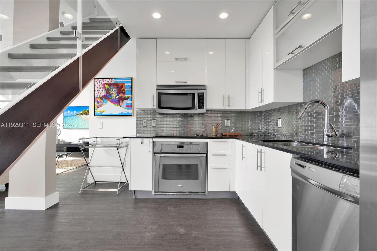 60 Southwest 13th Street, Unit 4607 Miami, FL 33130 - Photo 8 of 39 a kitchen with stainless steel appliances granite countertop a stove a sink and a microwave