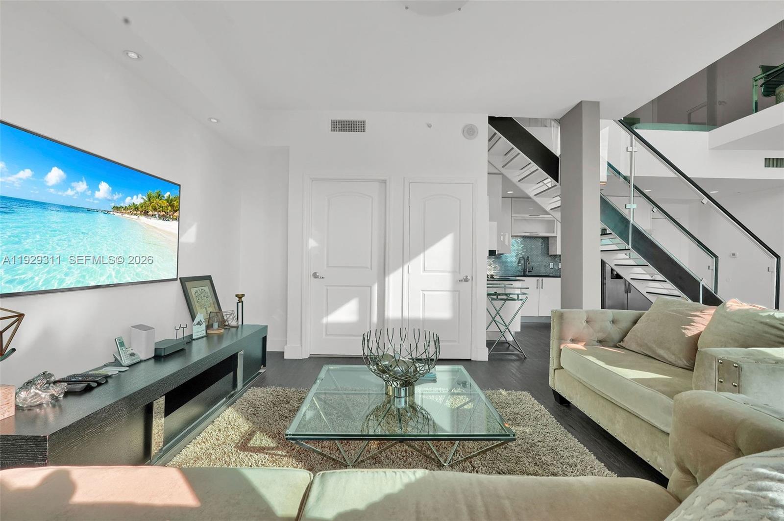 60 Southwest 13th Street, Unit 4607 Miami, FL 33130 - Photo 9 of 39 a living room with furniture and wooden floor