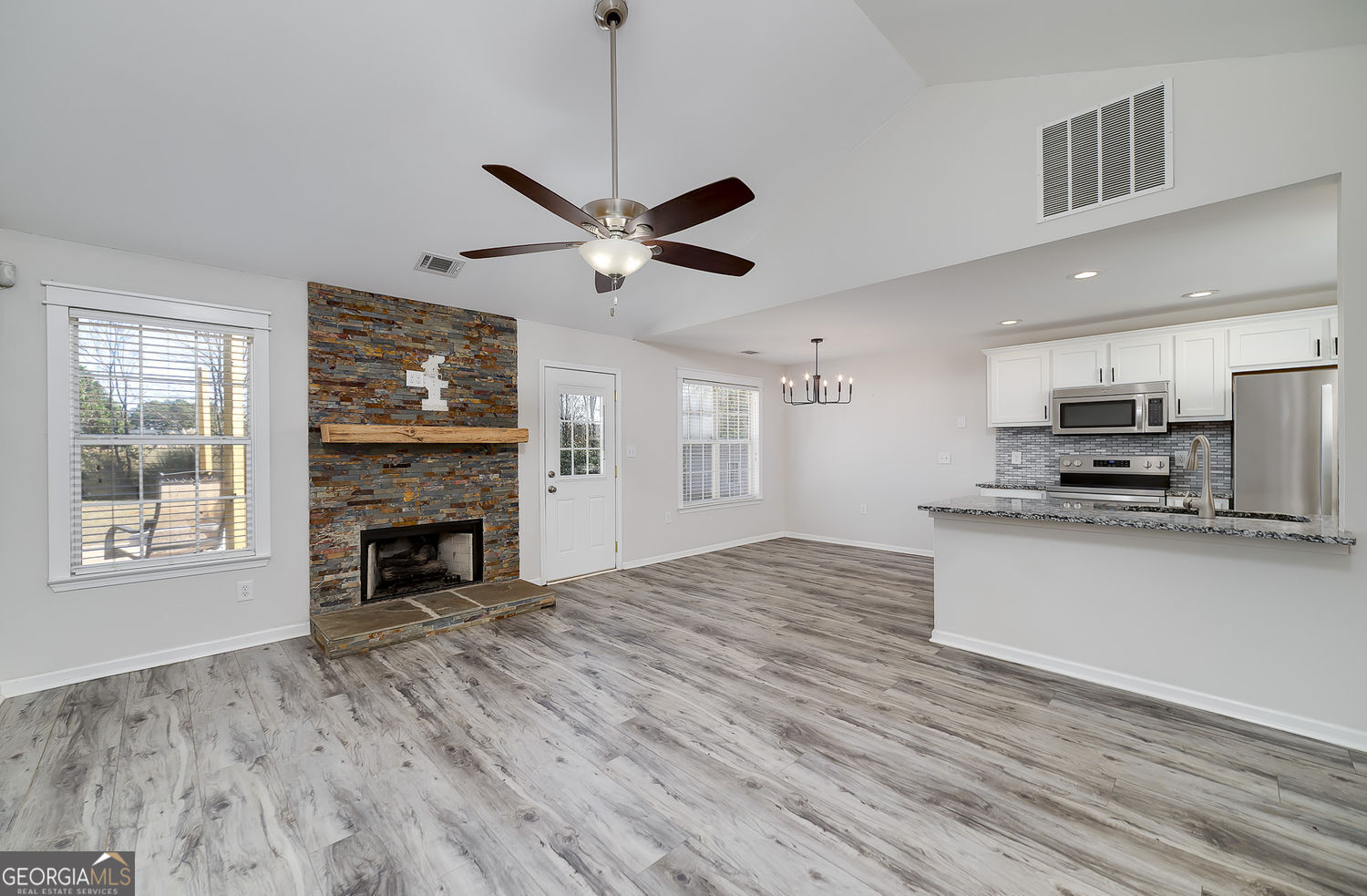 524 Leguin Mill Road Locust Grove, GA 30248 - Photo 18 of 44 a view of kitchen with microwave a stove and wooden floor