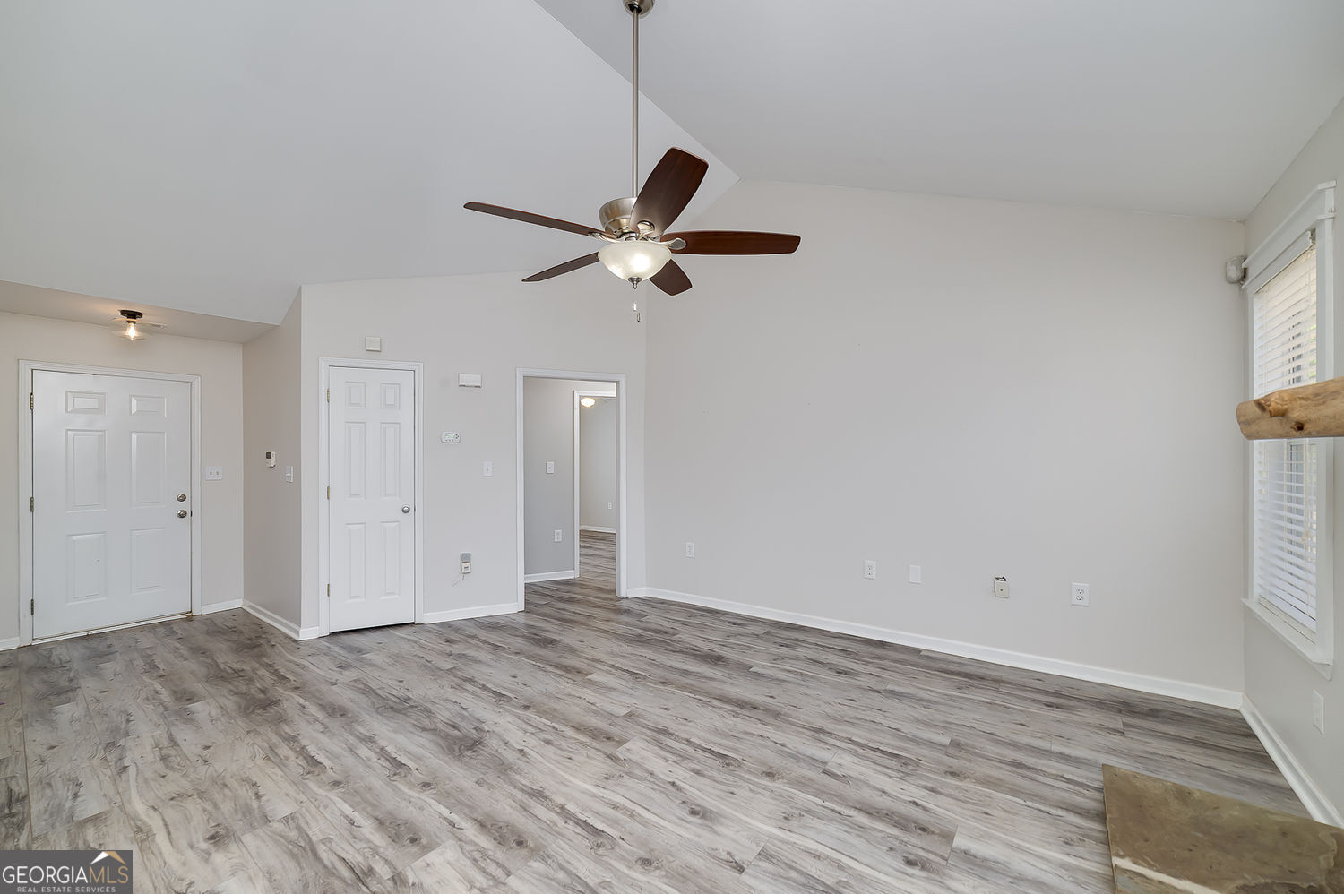 524 Leguin Mill Road Locust Grove, GA 30248 - Photo 20 of 44 a view of a room with wooden floor and a ceiling fan