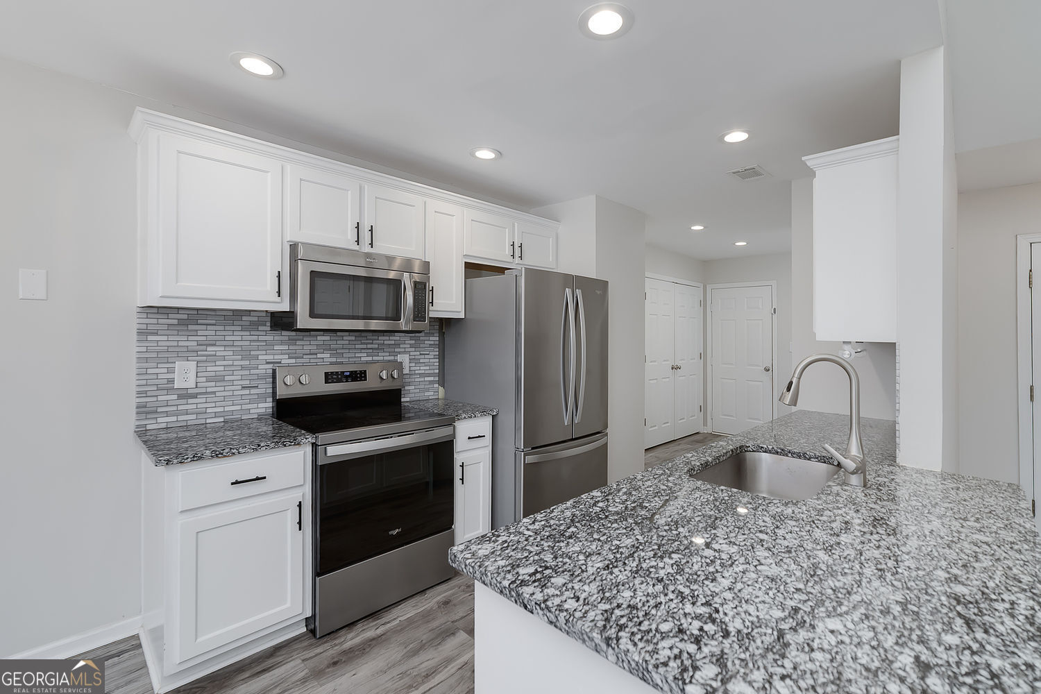 524 Leguin Mill Road Locust Grove, GA 30248 - Photo 23 of 44 a kitchen with stainless steel appliances granite countertop a sink stove and refrigerator