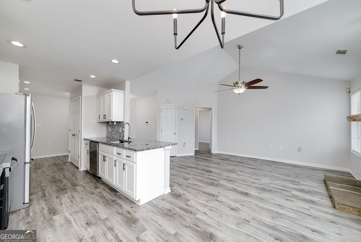 524 Leguin Mill Road Locust Grove, GA 30248 - Photo 24 of 44 a kitchen with stainless steel appliances a stove a sink and white cabinets
