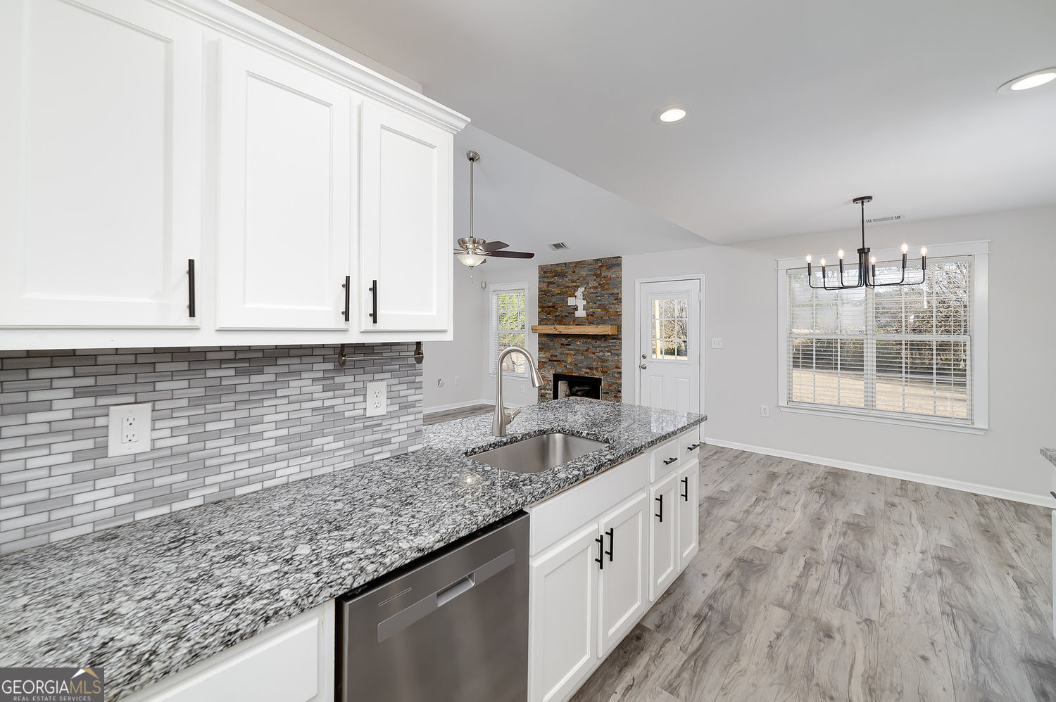 524 Leguin Mill Road Locust Grove, GA 30248 - Photo 25 of 44 a kitchen with granite countertop a sink stove and cabinets