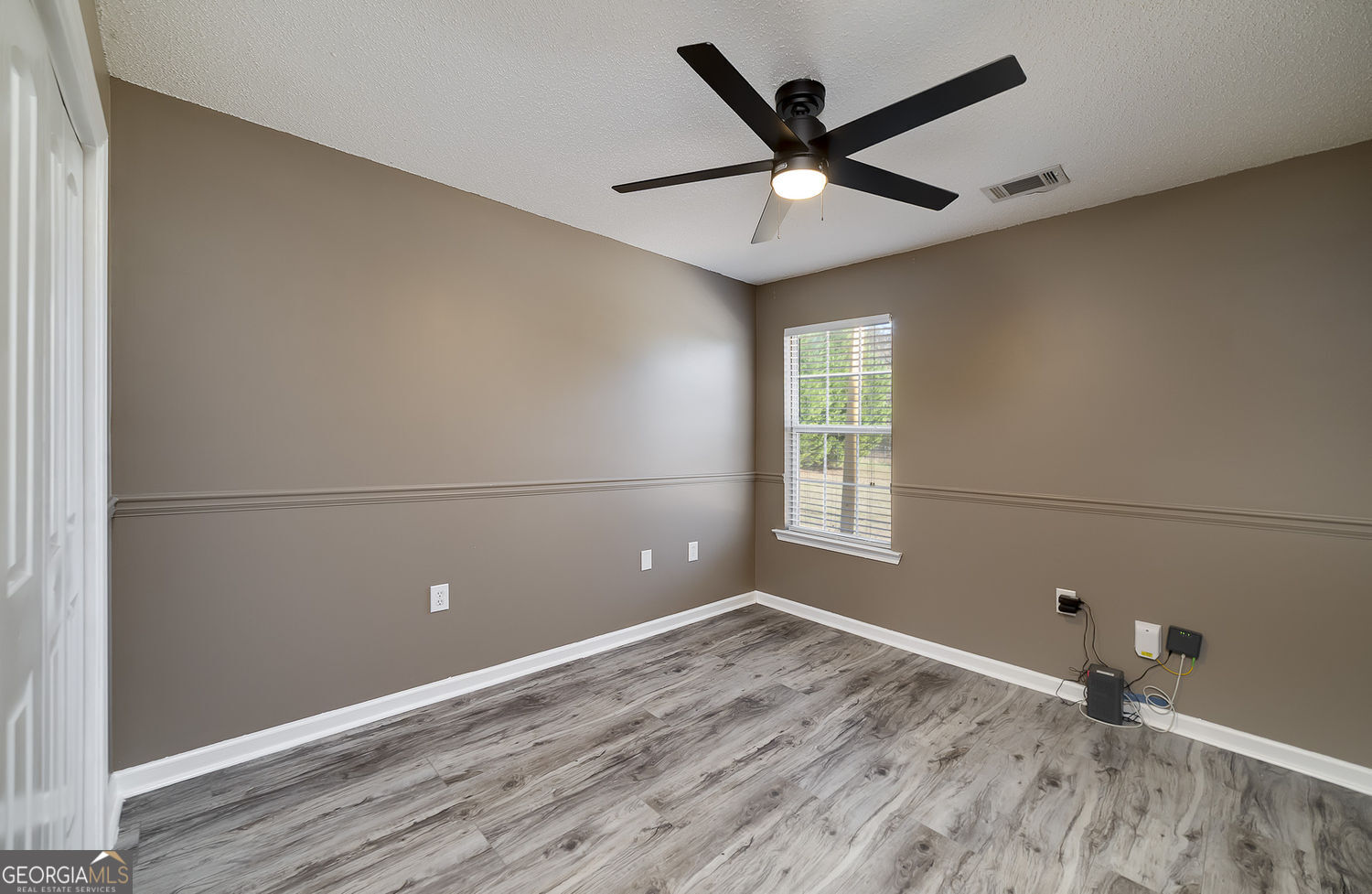 524 Leguin Mill Road Locust Grove, GA 30248 - Photo 35 of 44 a view of a livingroom with a ceiling fan and wooden floor