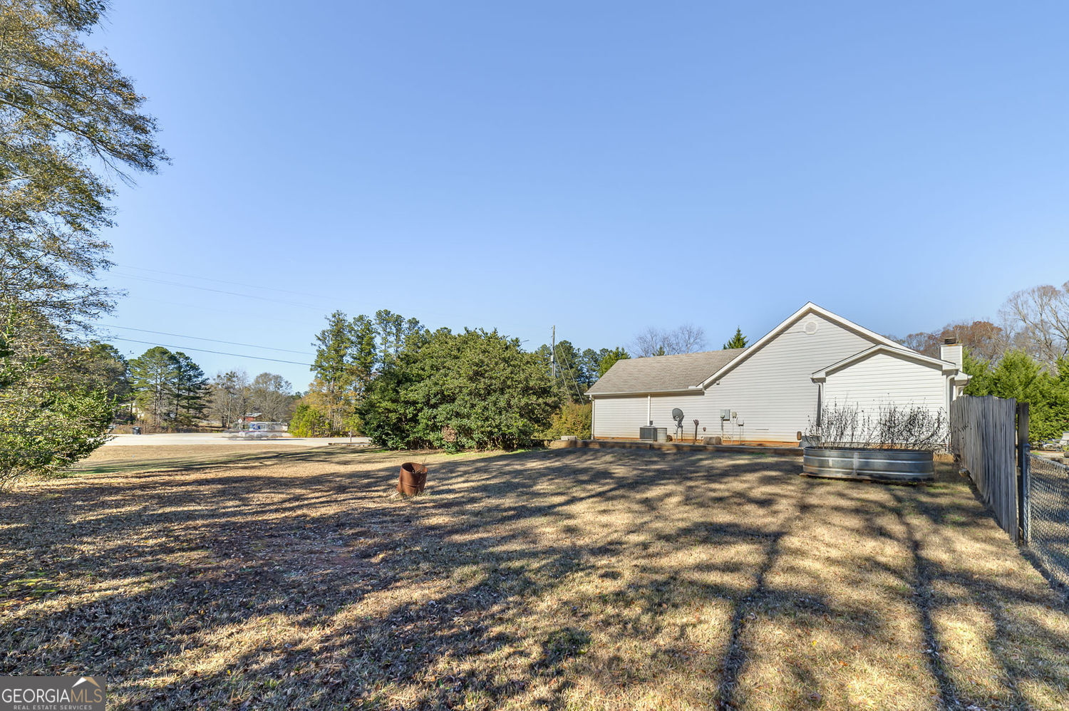 524 Leguin Mill Road Locust Grove, GA 30248 - Photo 40 of 44 a view of a dry yard with wooden fence