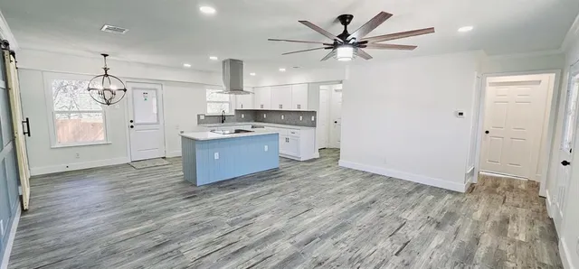 a view of kitchen with sink and wooden floor