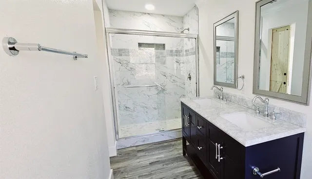 a bathroom with a granite countertop sink mirror and double