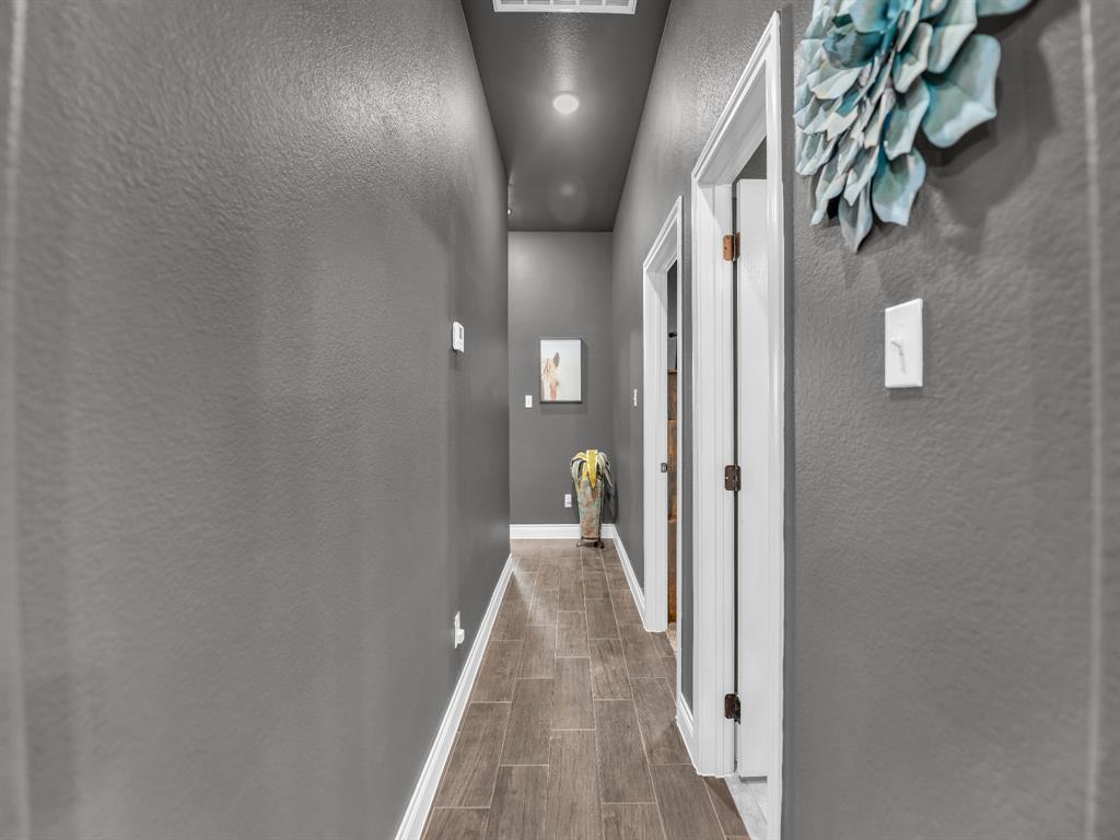 156 Cottongame Road Weatherford, TX 76088 - Photo 21 of 35 a view of a hallway with wooden floor