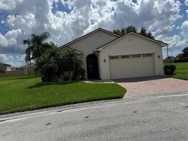 a view of a house with a yard and garage