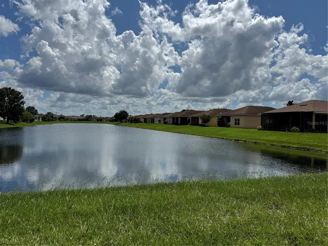 a view of a lake with houses in the back