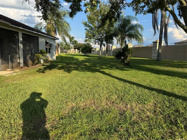 a view of a house with a yard and tree s