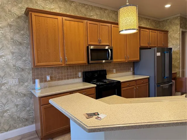 a kitchen with a refrigerator and a stove
