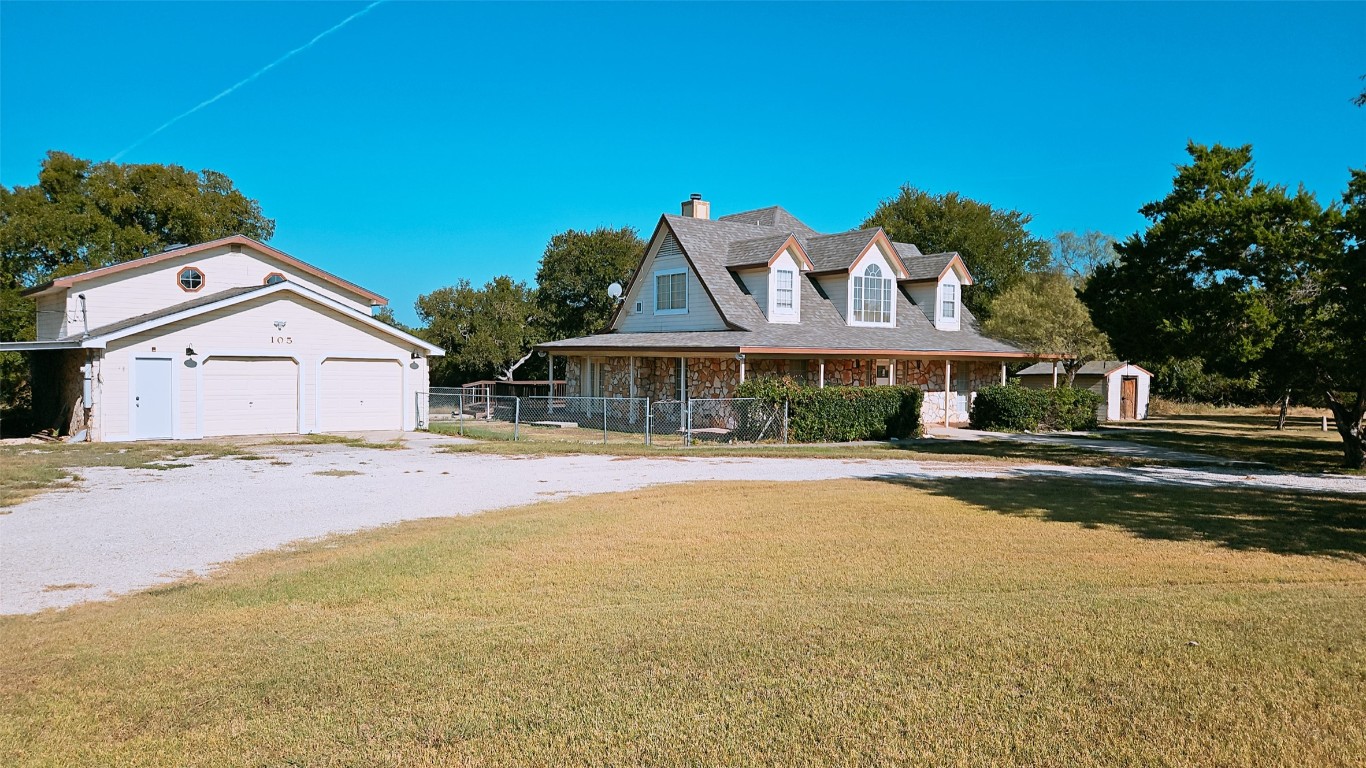 105 Meadow Drive Georgetown, TX 78633 - Photo 1 of 24 a front view of a house with a yard and garage