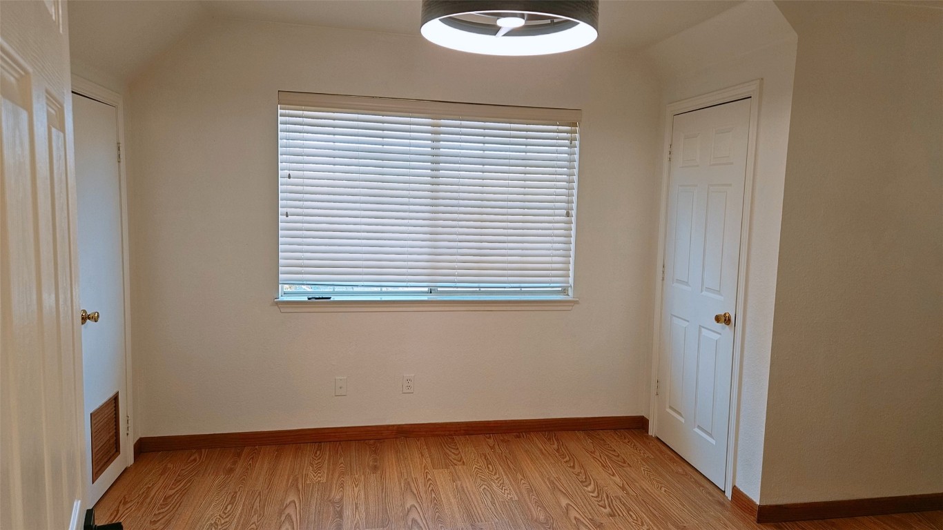 105 Meadow Drive Georgetown, TX 78633 - Photo 11 of 24 a view of an empty room with wooden floor and a window