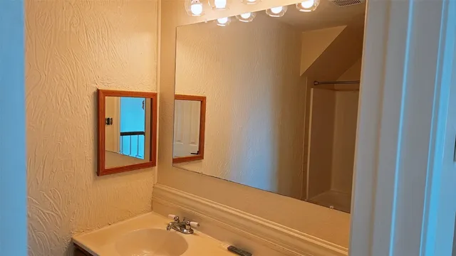 a bathroom with a sink and a mirror