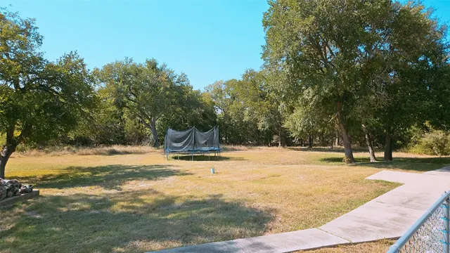 a view of a yard with basketball court