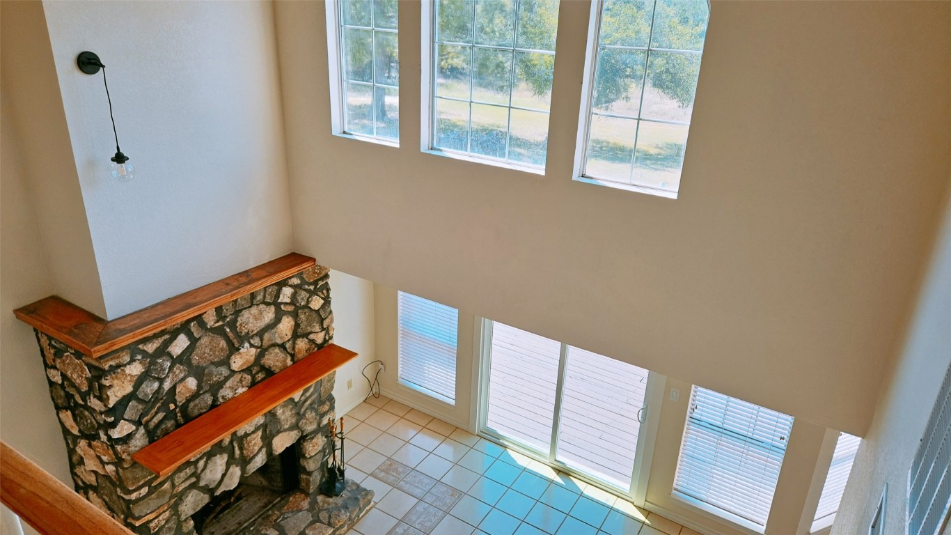 105 Meadow Drive Georgetown, TX 78633 - Photo 5 of 24 a view of wooden staircase with a black and white walls