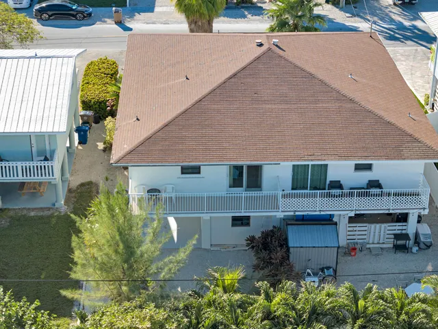 a aerial view of a house with a yard and sitting area