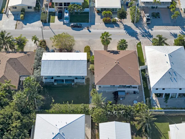an aerial view of a house with garden space and a patio