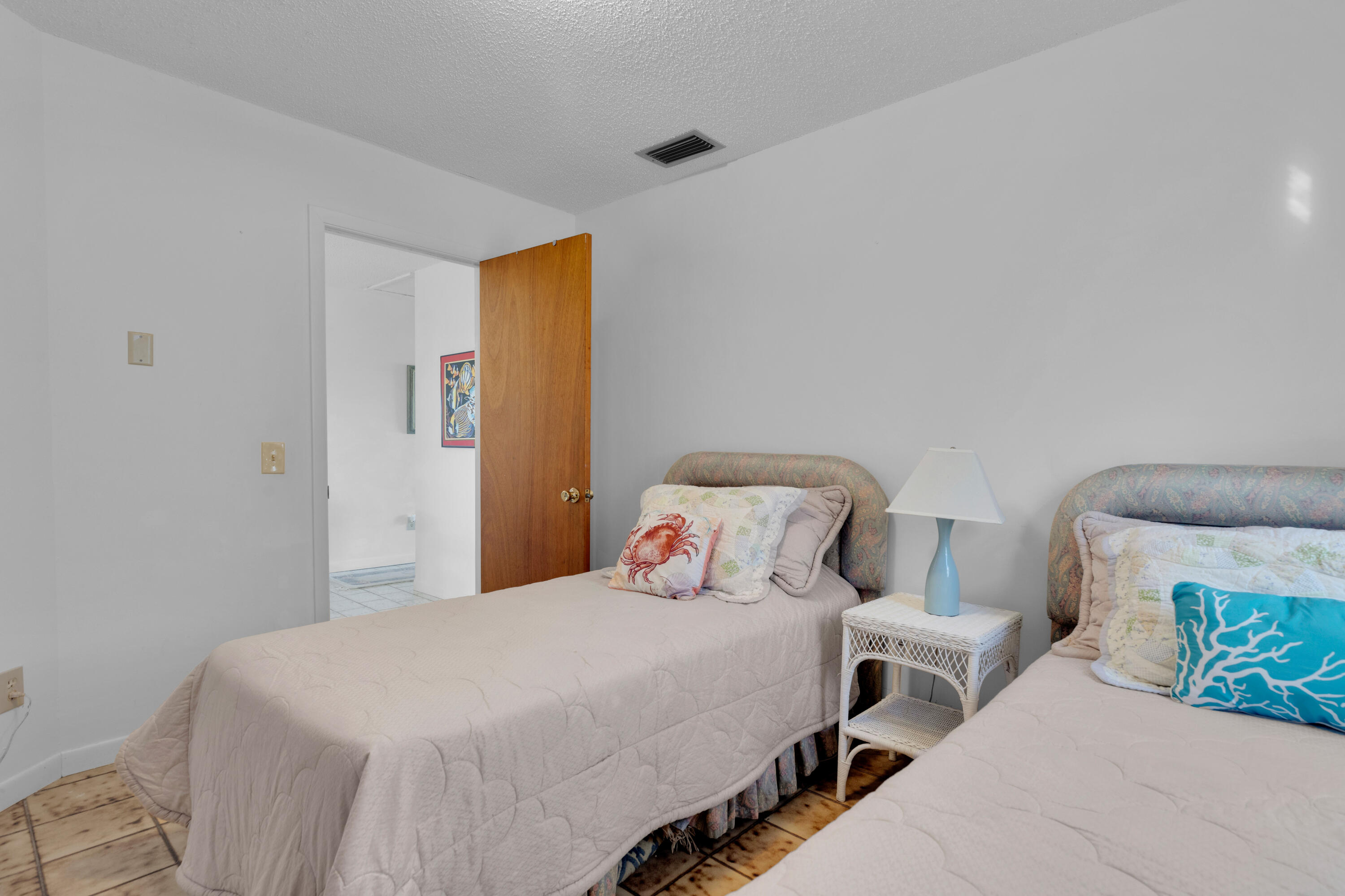 300 3rd Street Key Colony Beach, FL 33051 - Photo 22 of 51 a bedroom with a bed and a lamp