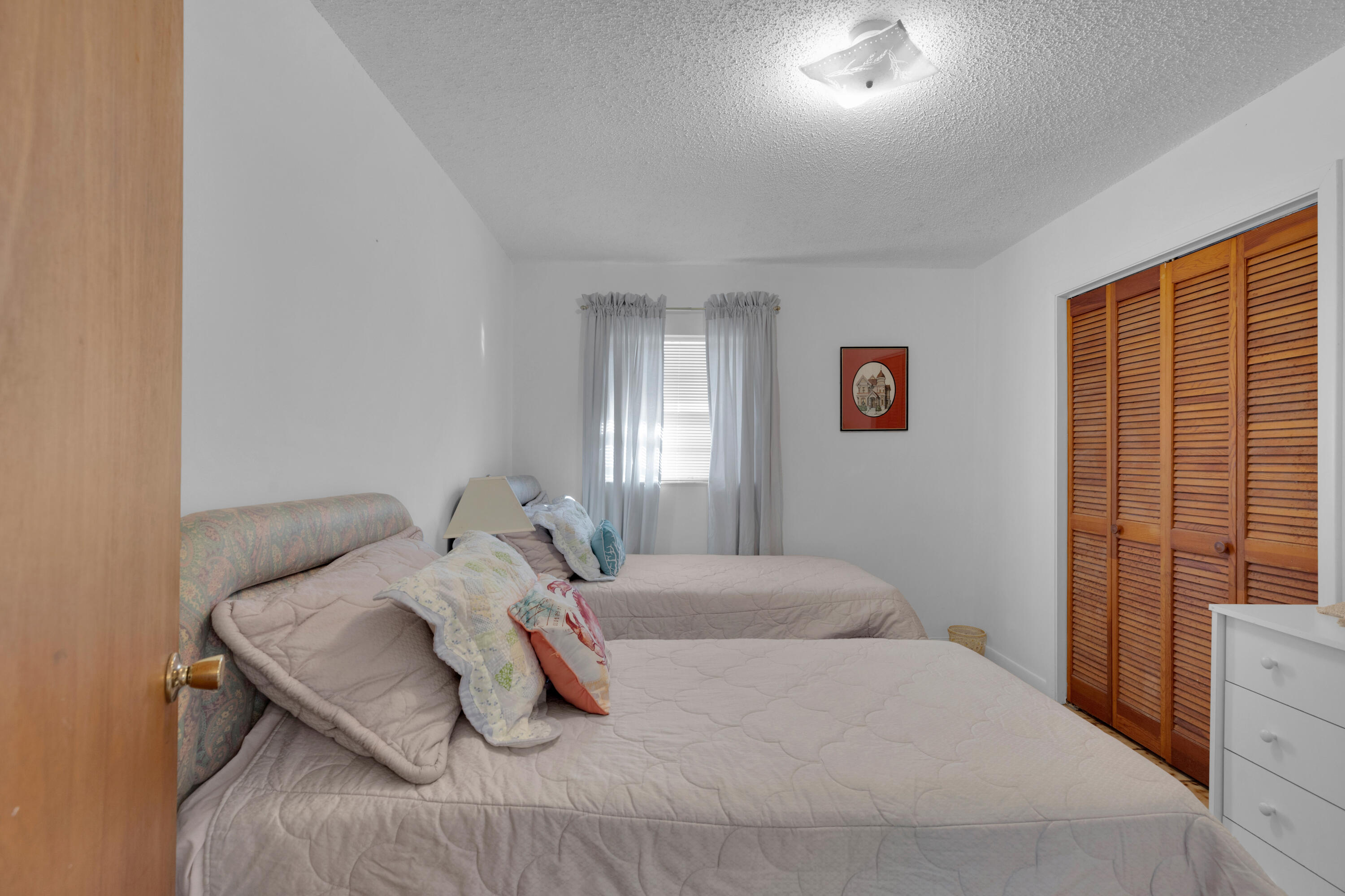 300 3rd Street Key Colony Beach, FL 33051 - Photo 23 of 51 a bedroom with a bed and a window
