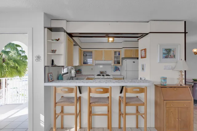 a kitchen with stainless steel appliances granite countertop a sink and a refrigerator