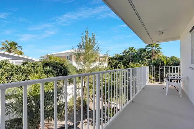 a view of a balcony with wooden fence