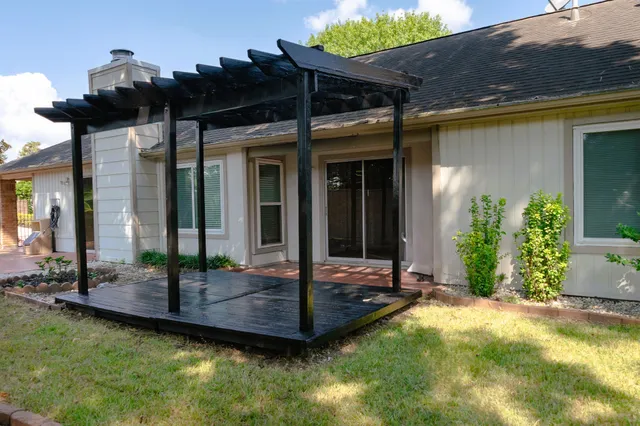 a view of backyard with outdoor seating and plants