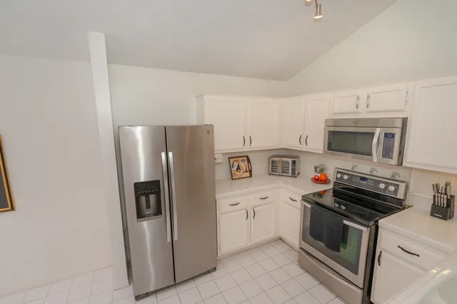 a view of a dining room with furniture and a window