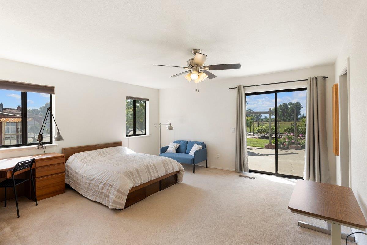 9930 Calvine Road Sacramento, CA 95829 - Photo 13 of 85 Large lower-level primary suite with a sliding door that opens just steps from the walking paths and gardens, creating an easy indoor-outdoor flow