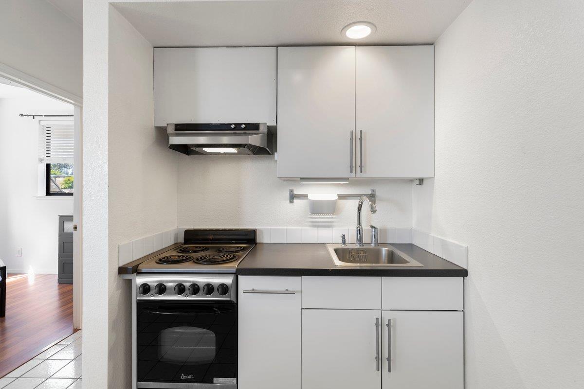 9930 Calvine Road Sacramento, CA 95829 - Photo 45 of 97 a kitchen with kitchen island a stove a sink and a stove