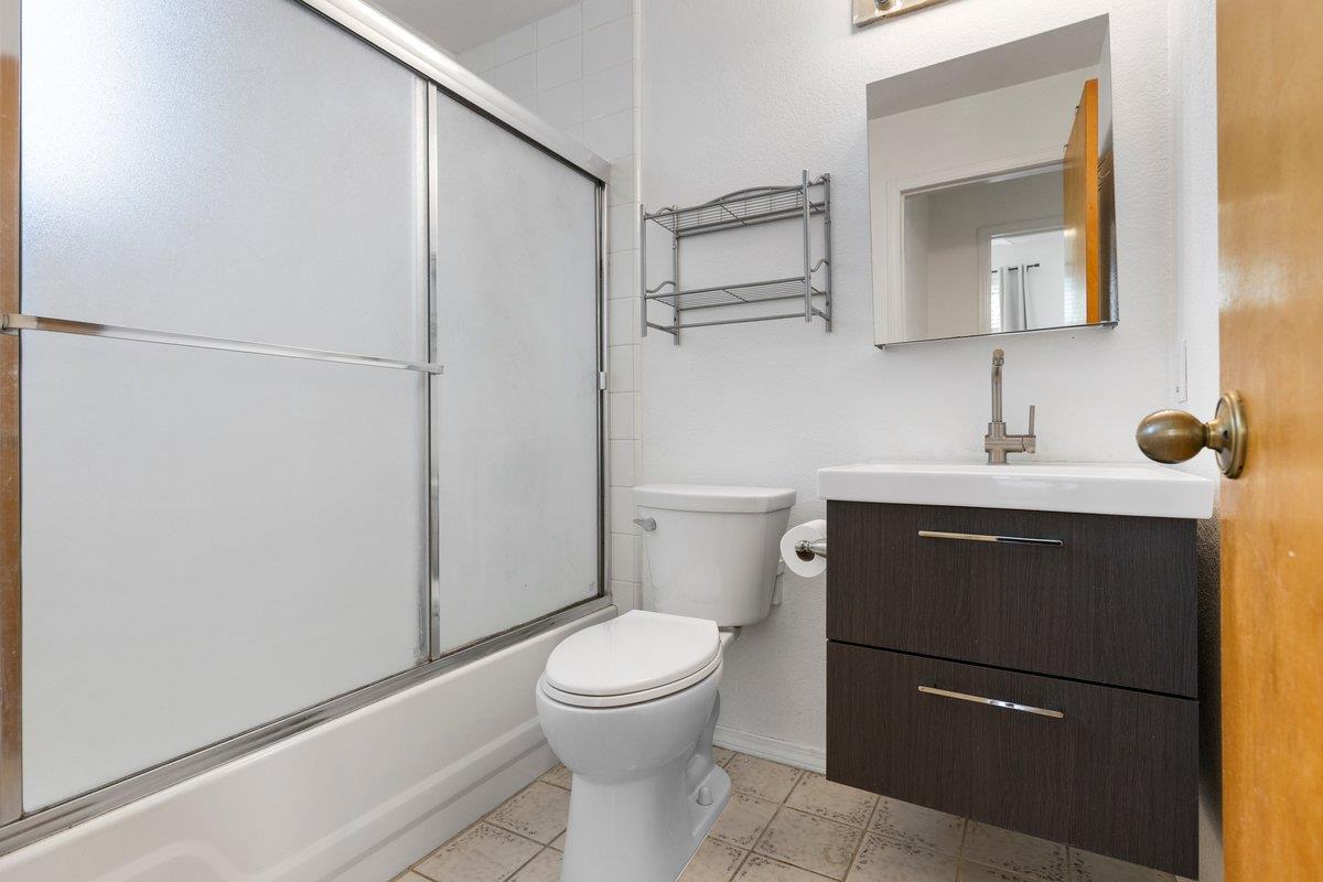 9930 Calvine Road Sacramento, CA 95829 - Photo 47 of 97 a bathroom with a toilet sink vanity and mirror